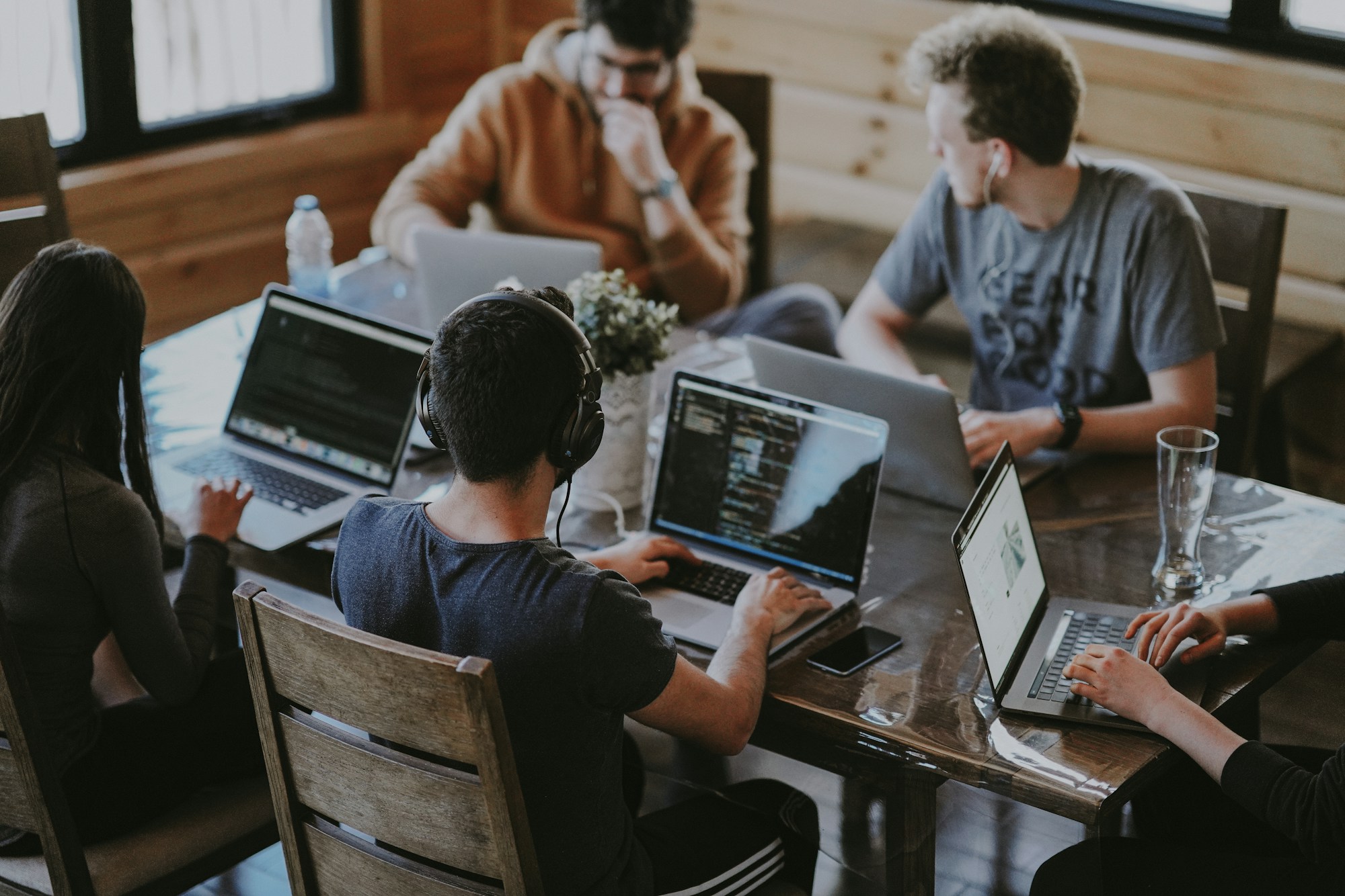People reviewing work together around laptops